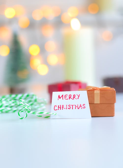 Brown Gift Box Beside a Greeting Card