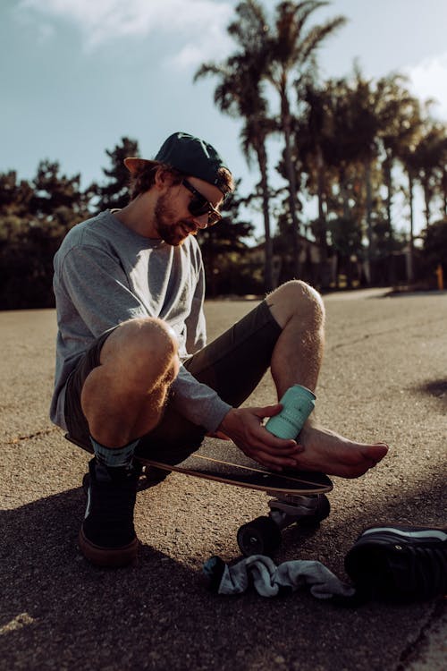 Man Sitting on a Skateboard