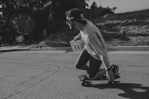 Man in Long Sleeve Shirt Skateboarding