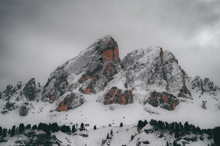 Snow Capped Mountain Under Gray Clouds