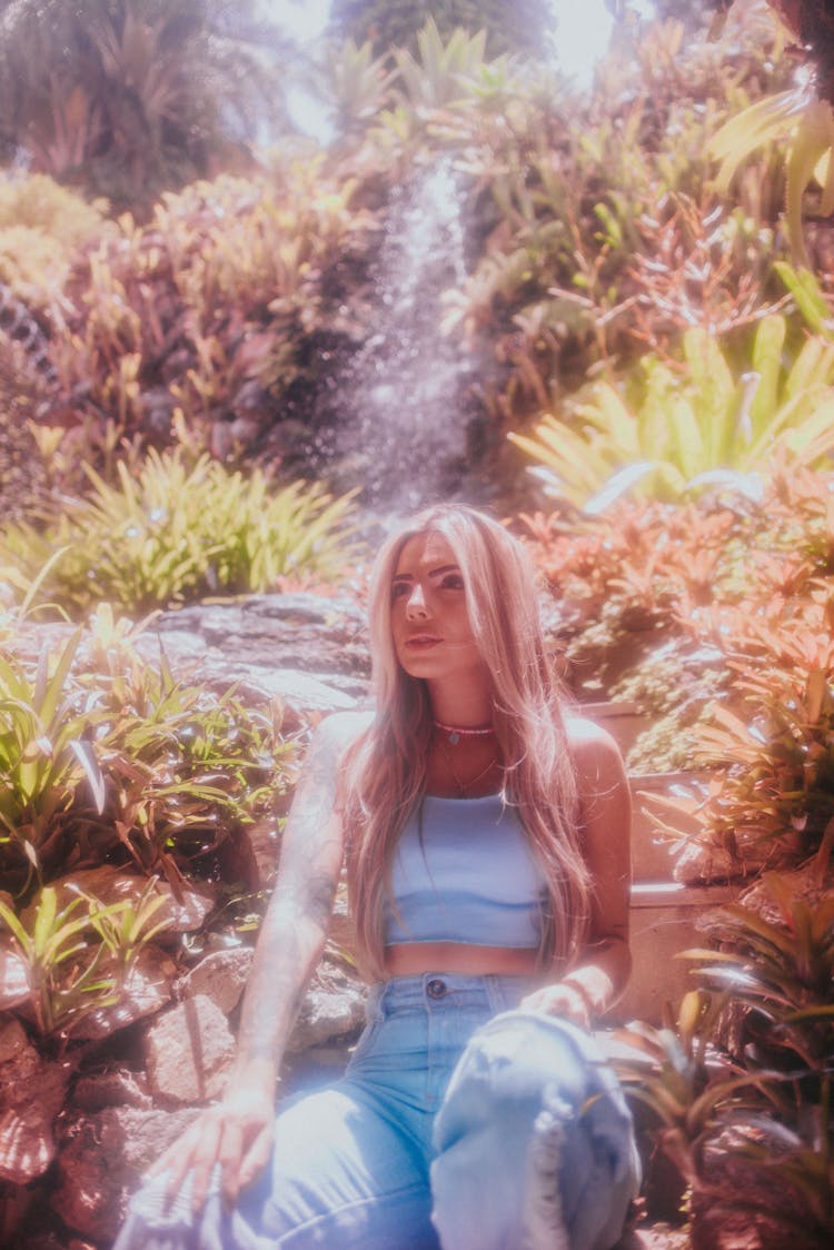 Blonde Woman By Stream And Waterfall