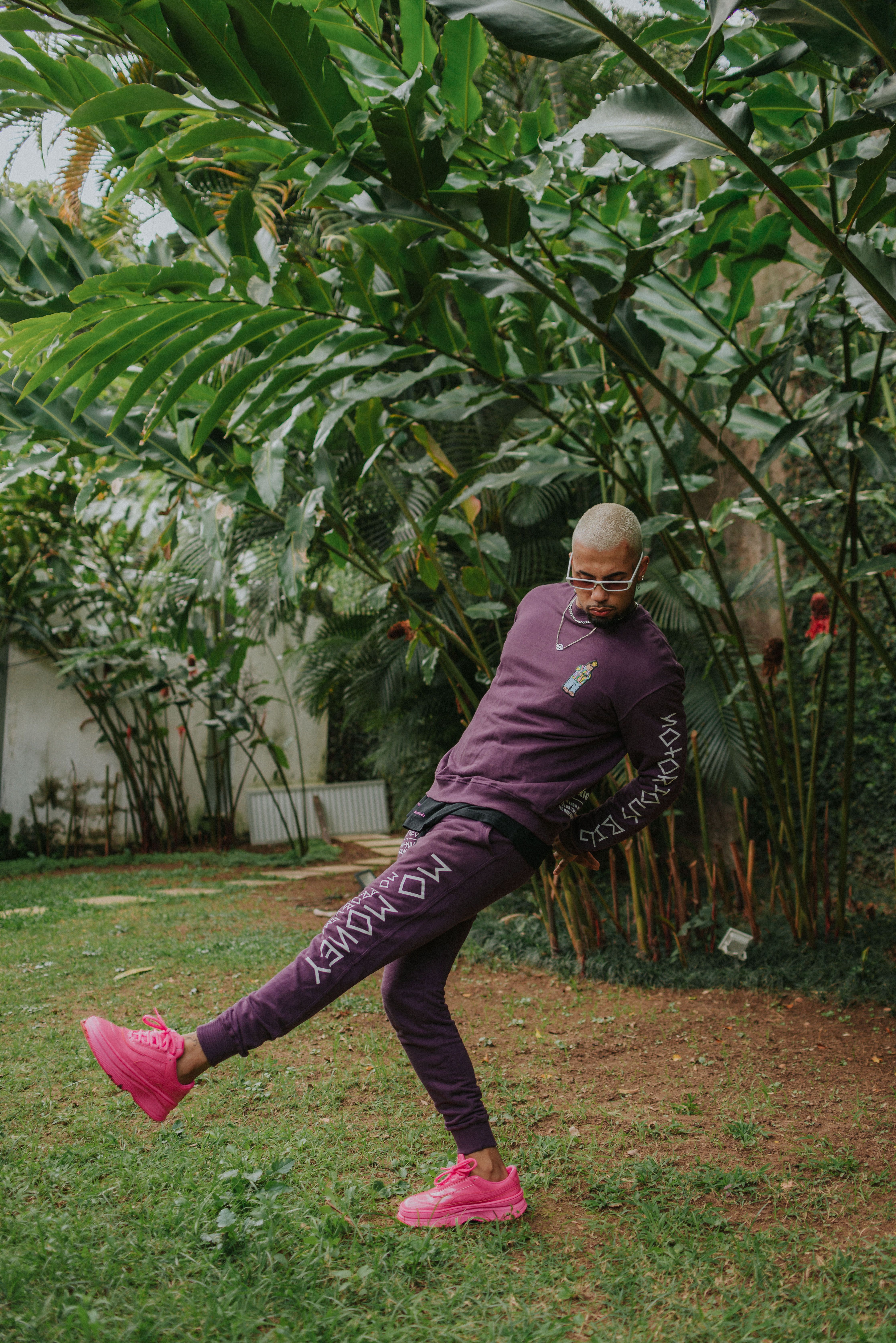 Man Wearing a Purple Sweatsuit Jumping 