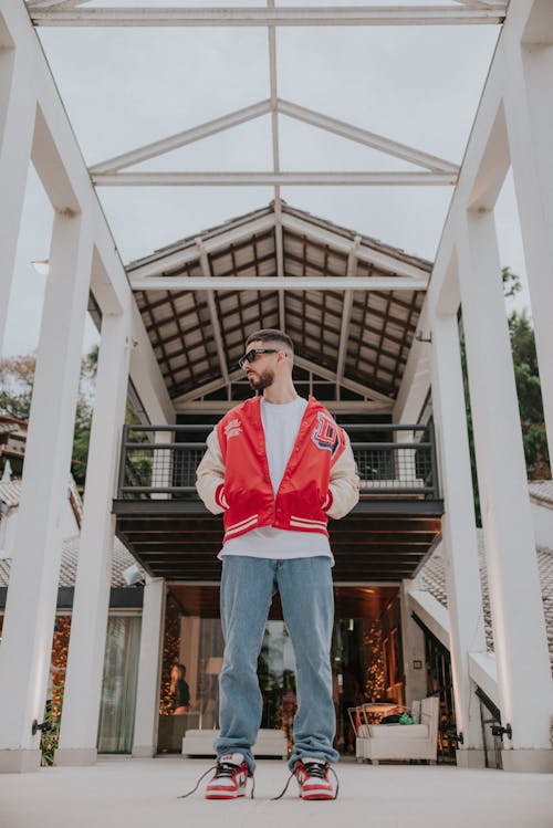 Free Man in Red and White Jacket Looking Sideways Stock Photo