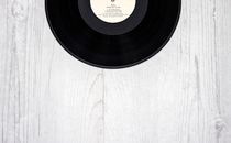 Black Vinyl Record on Wooden Surface