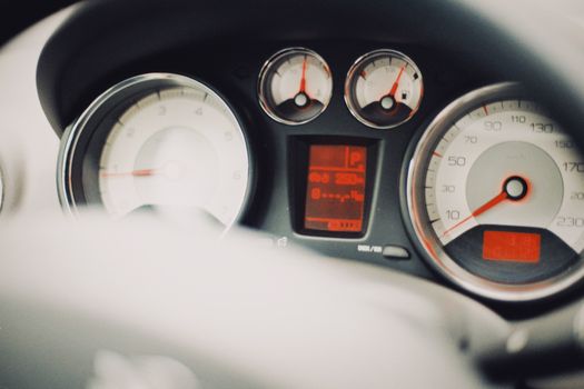 Detailed image of a car dashboard showcasing speedometer and gauges.