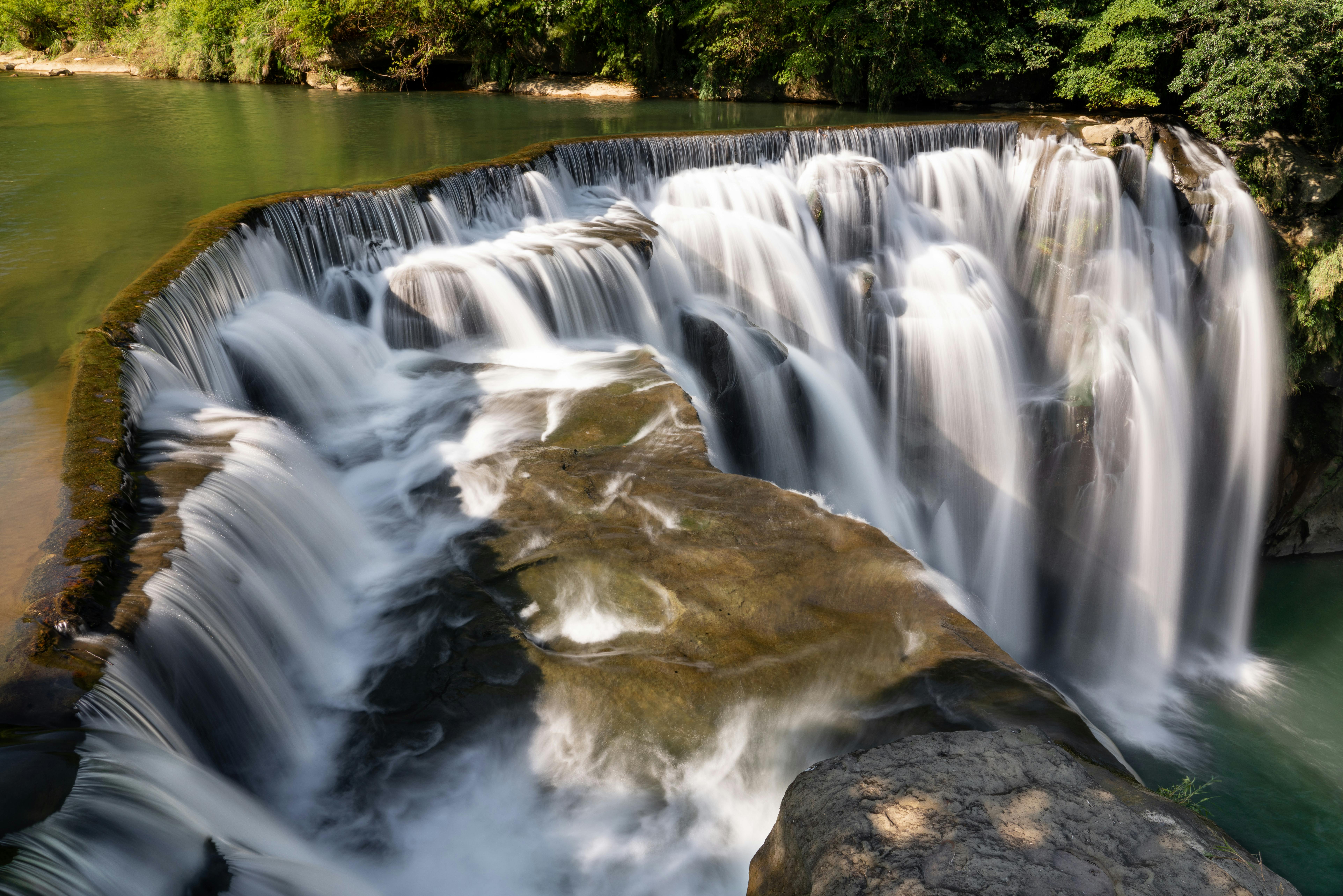 Beautiful cascading waterfall surrounded by lush greenery in New Taipei City, Taiwan.