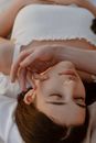 Pretty Young Woman Laying and Male Hand Touching Her face