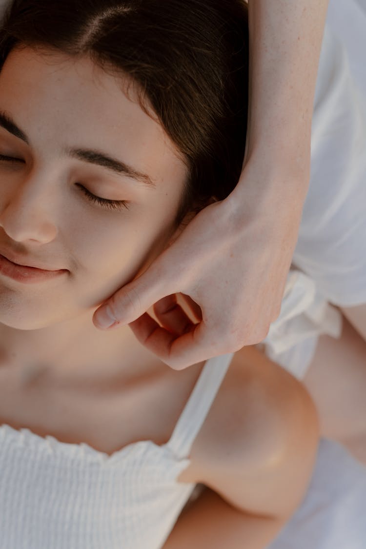 Pretty Girl With Closed Eyes Smiling When Male Hand Touching Her Face