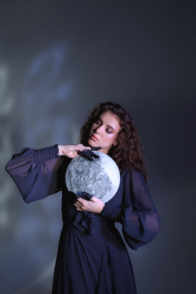 Woman With Painted Fingers Posing With A Moon