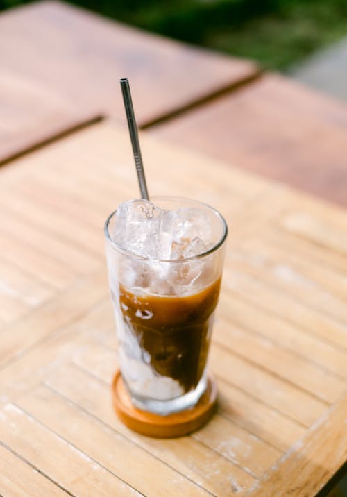 Clear Drinking Glass with Brown Liquid