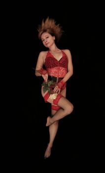 Woman posing in red lingerie with a rose on a black background, evocative and artistic.