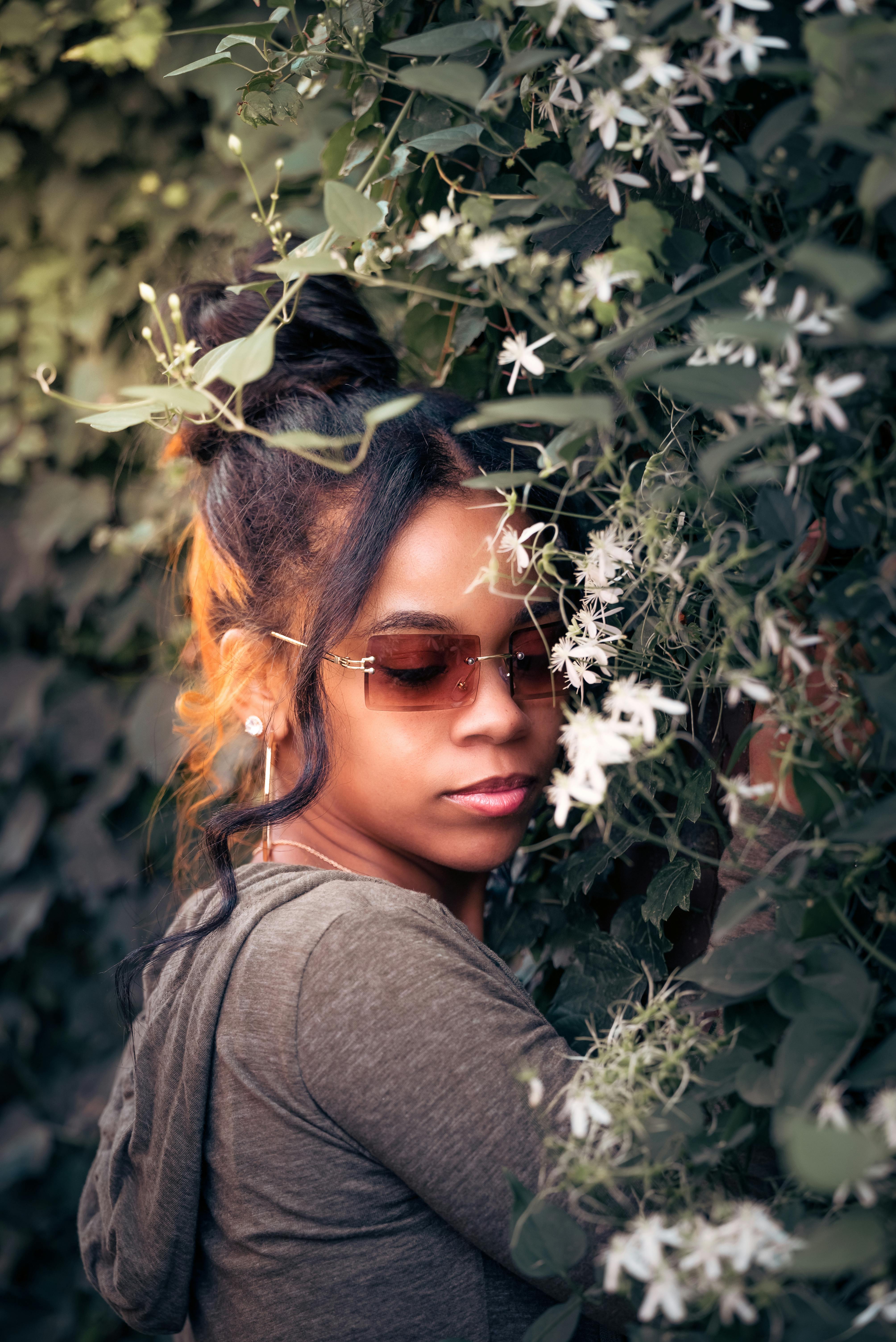 Woman Wearing a Sunglasses Holding Vine Plants · Free Stock Photo