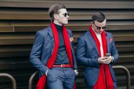 Well-Dressed Men Leaning on Railing