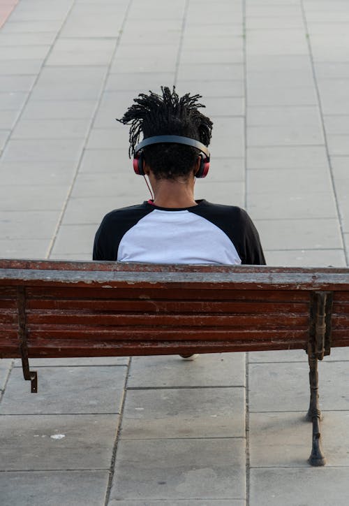 Free Man With Headphones Sitting on a Bench Stock Photo