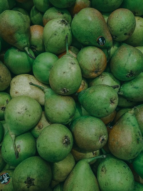 Free A bountiful display of fresh green pears at a market in France, showcasing their natural color and texture. Stock Photo