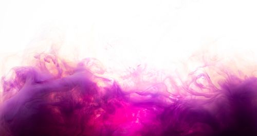 Free Abstract purple and pink smoke swirling on white background creating an artistic effect. Stock Photo