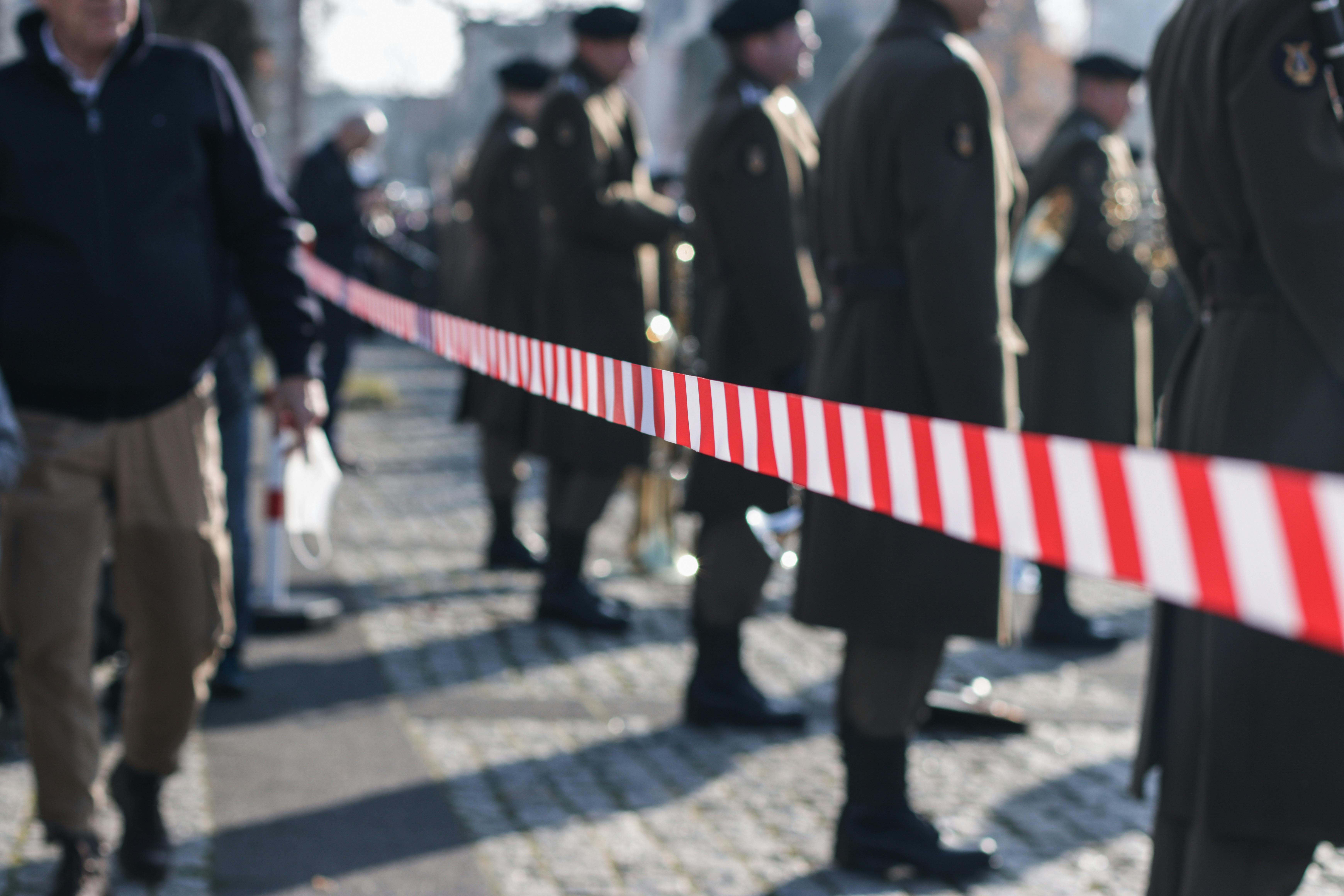 soldiers standing behind tape