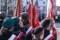A ceremonial military parade displaying vibrant flags and uniforms with a patriotic theme.