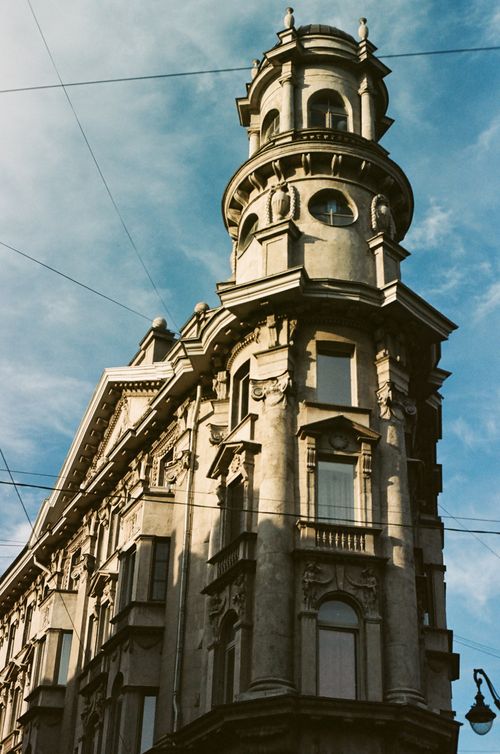 Free A historic building showcasing ornate architectural design under a clear blue sky, captured in a vertical shot. Stock Photo