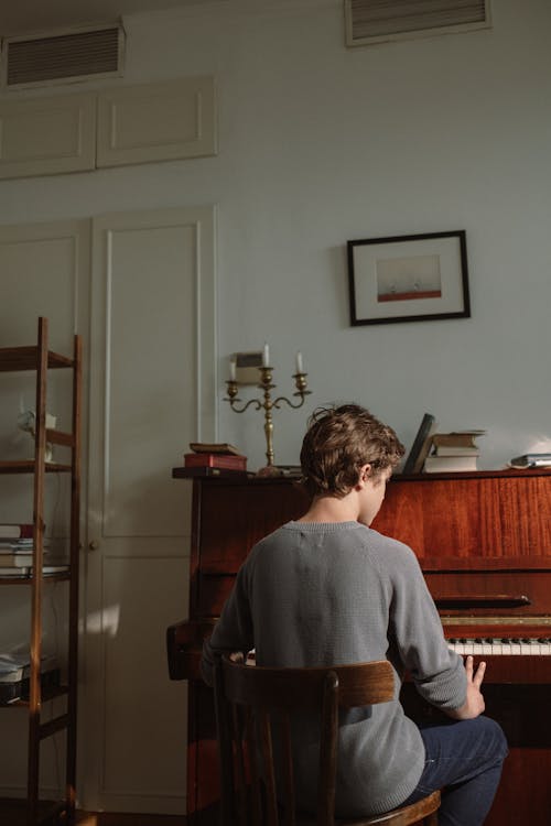Boy Playing a Wooden Piano