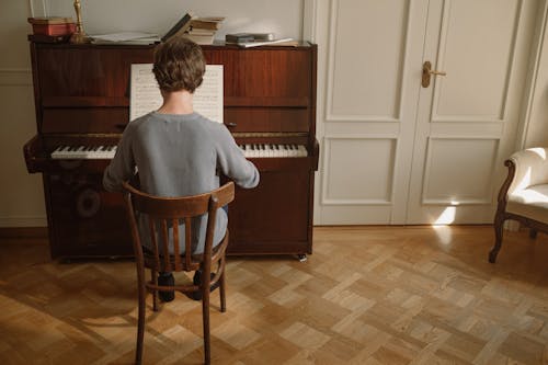 Back View of a Person Playing Piano