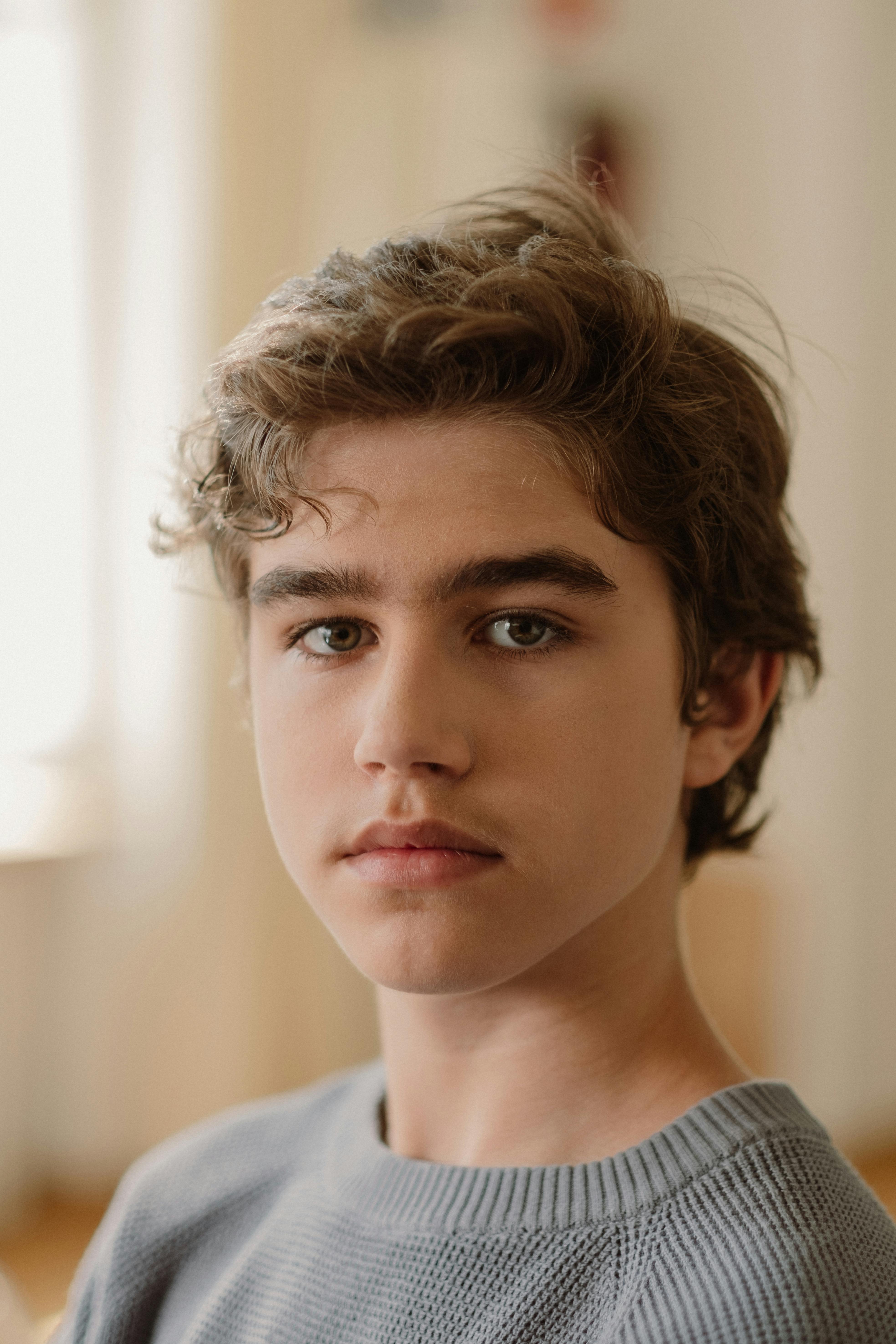 teenager in gray shirt posing