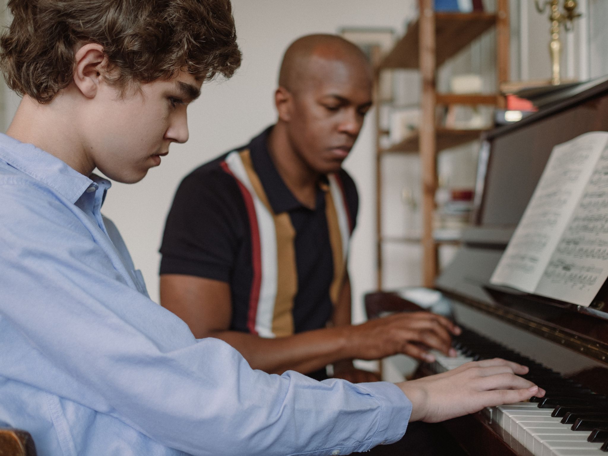 Piano lesson with a teacher and student