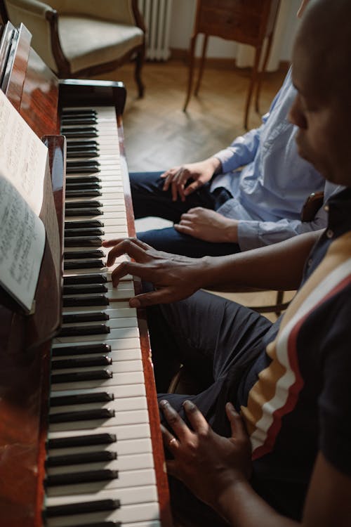 Piano Teacher Playing a Piano