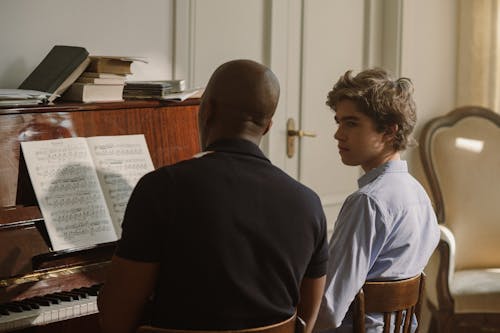 Man and Boy Playing Piano Together