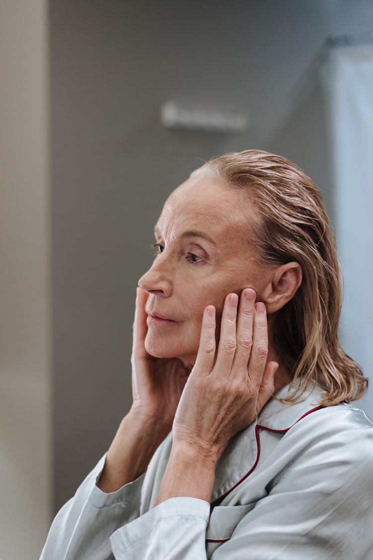 Portrait Of Blond Haired Elderly Woman In Bathroom