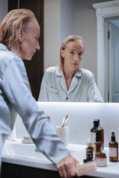 Elderly woman engaging in her morning self-care routine by the bathroom mirror.