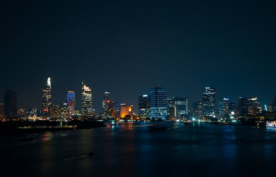 Breathtaking view of Ho Chi Minh City's skyline at night, beautifully lit across the Saigon River.