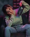 Girl Sitting in an Armchair and Holding a VHS Videotape