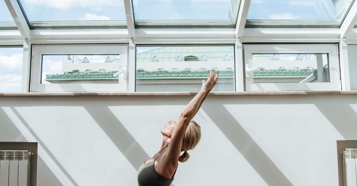 Ceiling Stretch Exercise Woman Doing Stretching in Room with Glass Ceiling · Free Stock Photo
