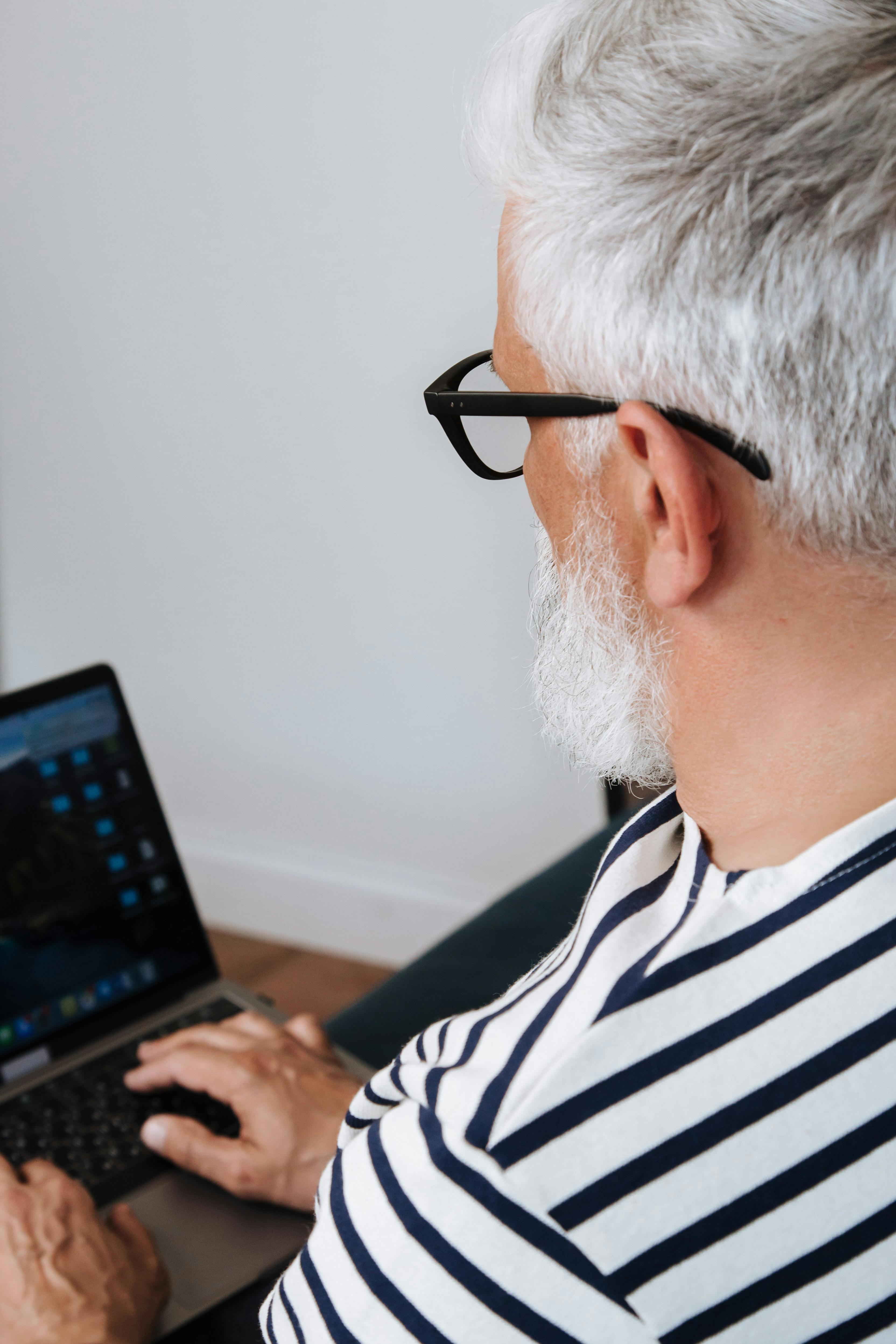 elderly man using a laptop