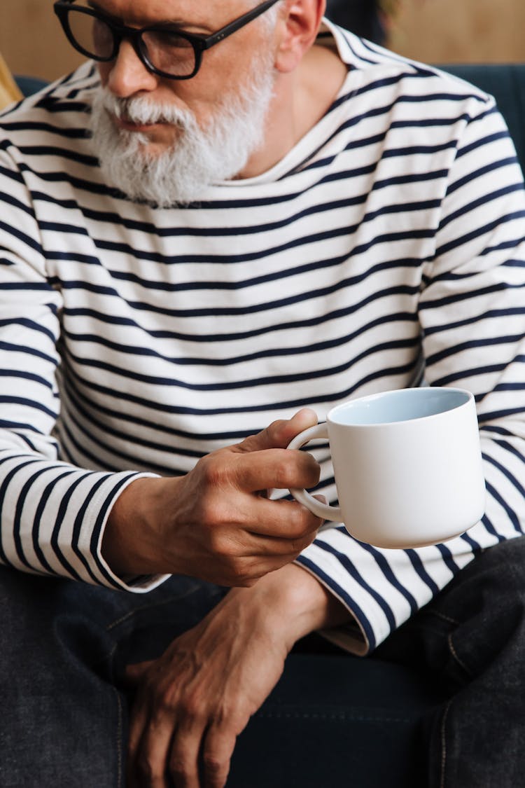 Man With Gray Beard Holding Cup In Hand