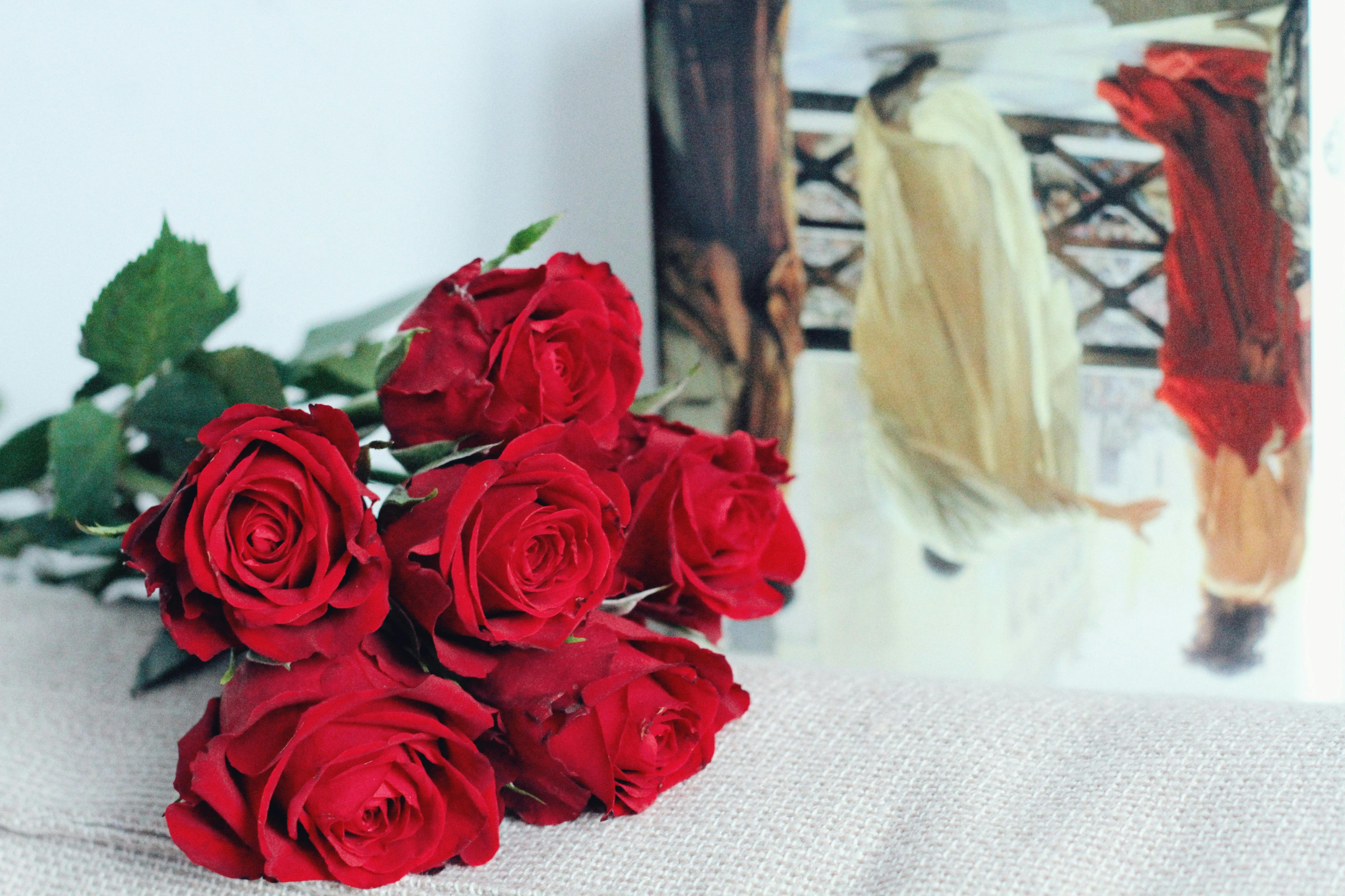 Stunning bouquet of red roses set against an artful backdrop, perfect for romantic decor.