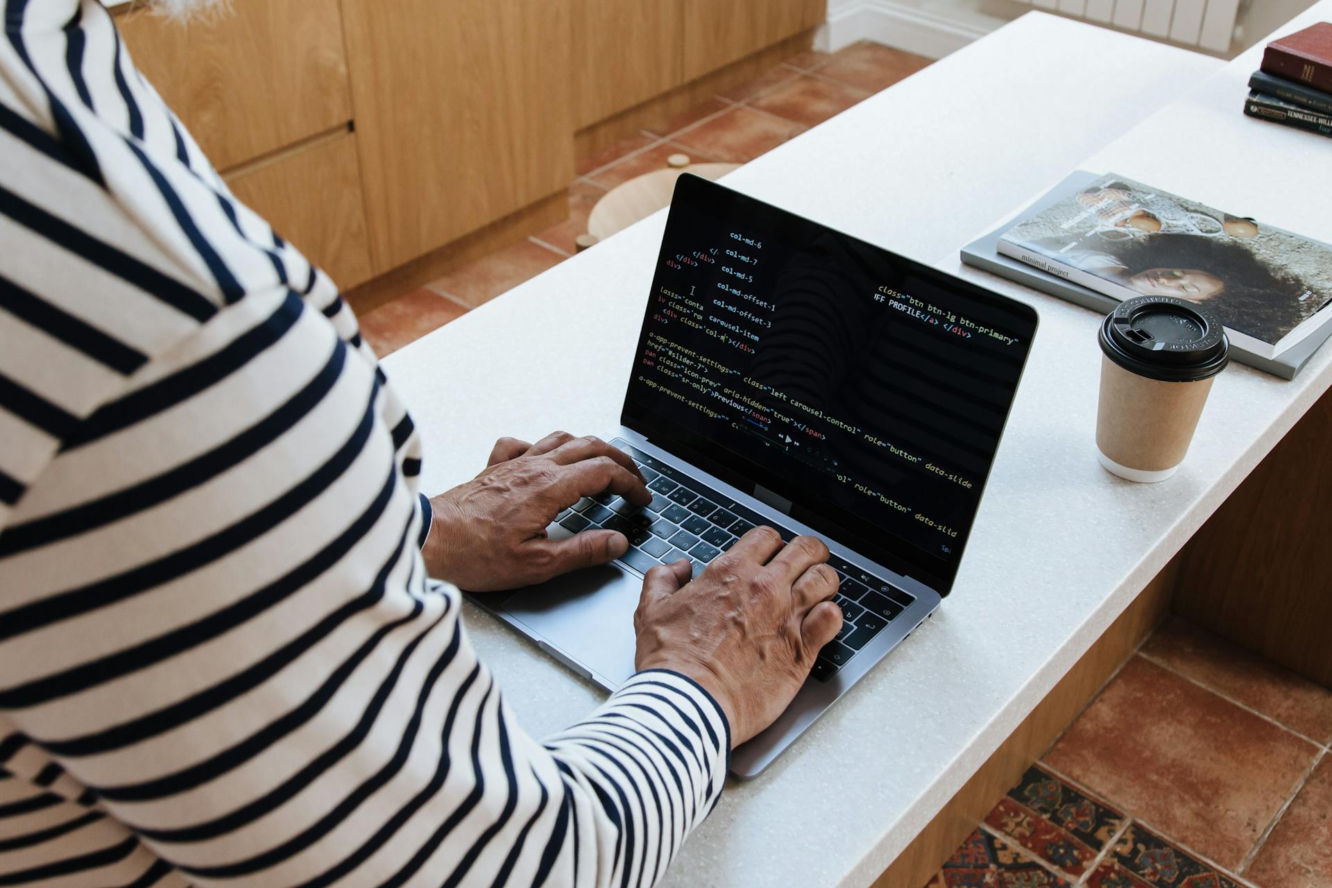 A High Angle View on Senior Male Typing on Laptop