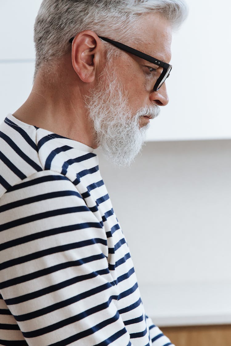 A Side View Of A Profile Of A Senior Adult Male Looking Down 