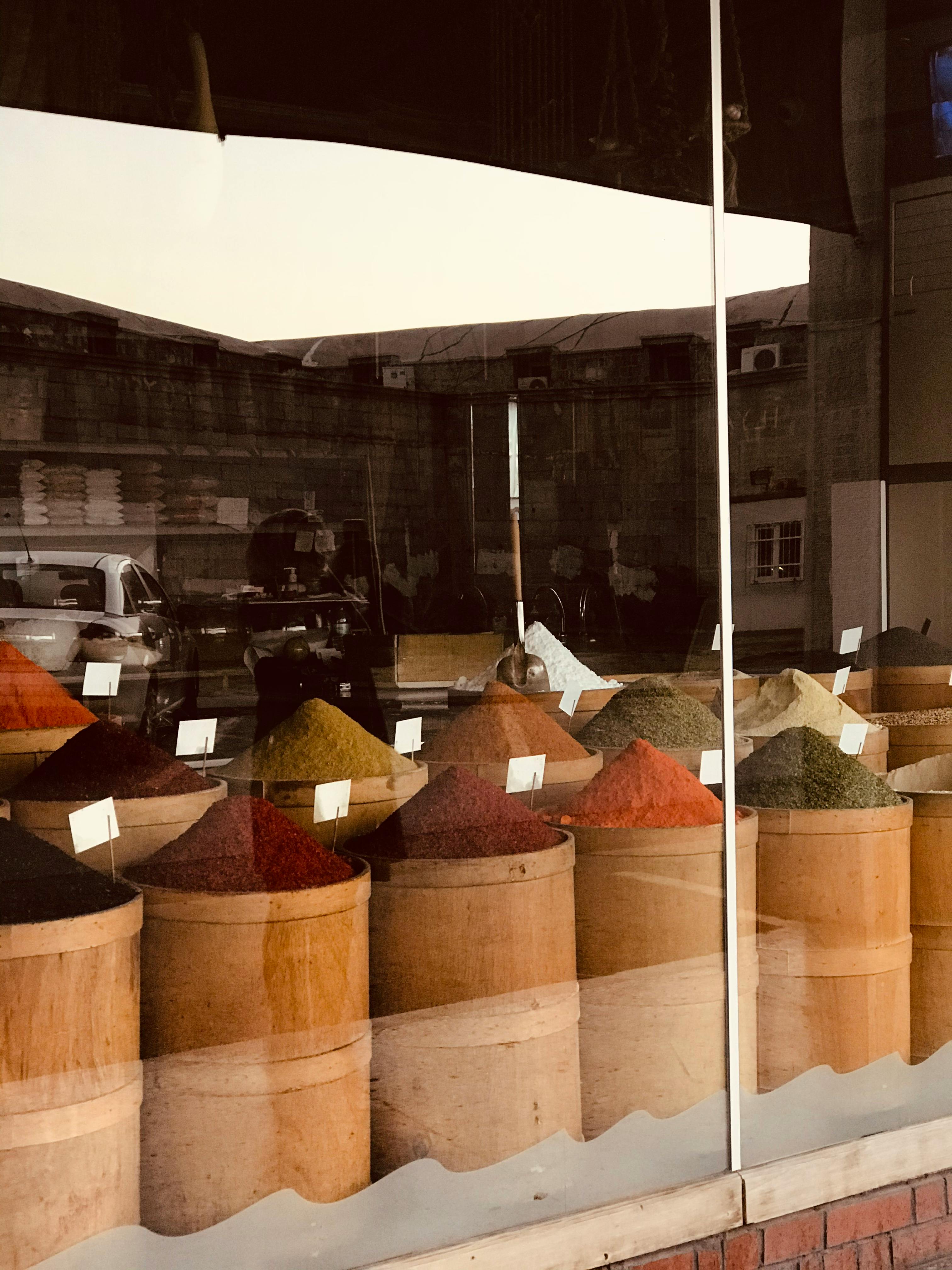 assorted spices on brown wooden barrels