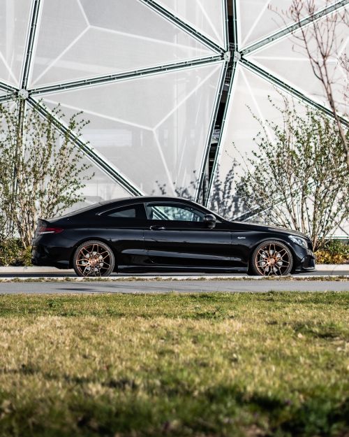 Free A stylish black coupe parked on a road with modern architectural background in Nürnberg, Germany. Stock Photo