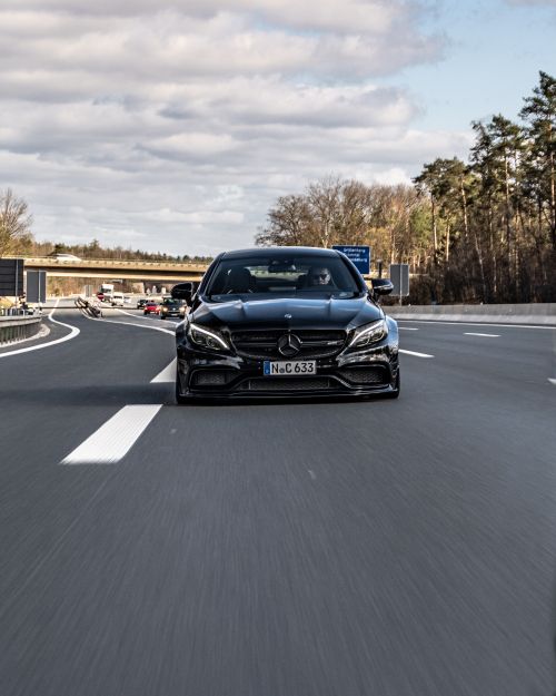 Free Black Mercedes-Benz cruising on a highway in Nürnberg, showcasing speed and elegance. Stock Photo