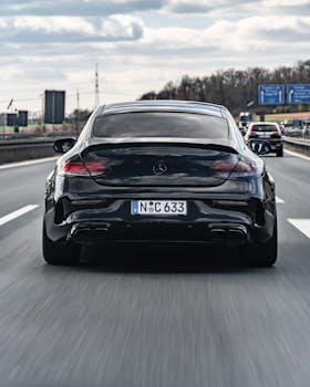 Black Mercedes car on the highway in Nürnberg, Germany, showcasing motion and perspective.
