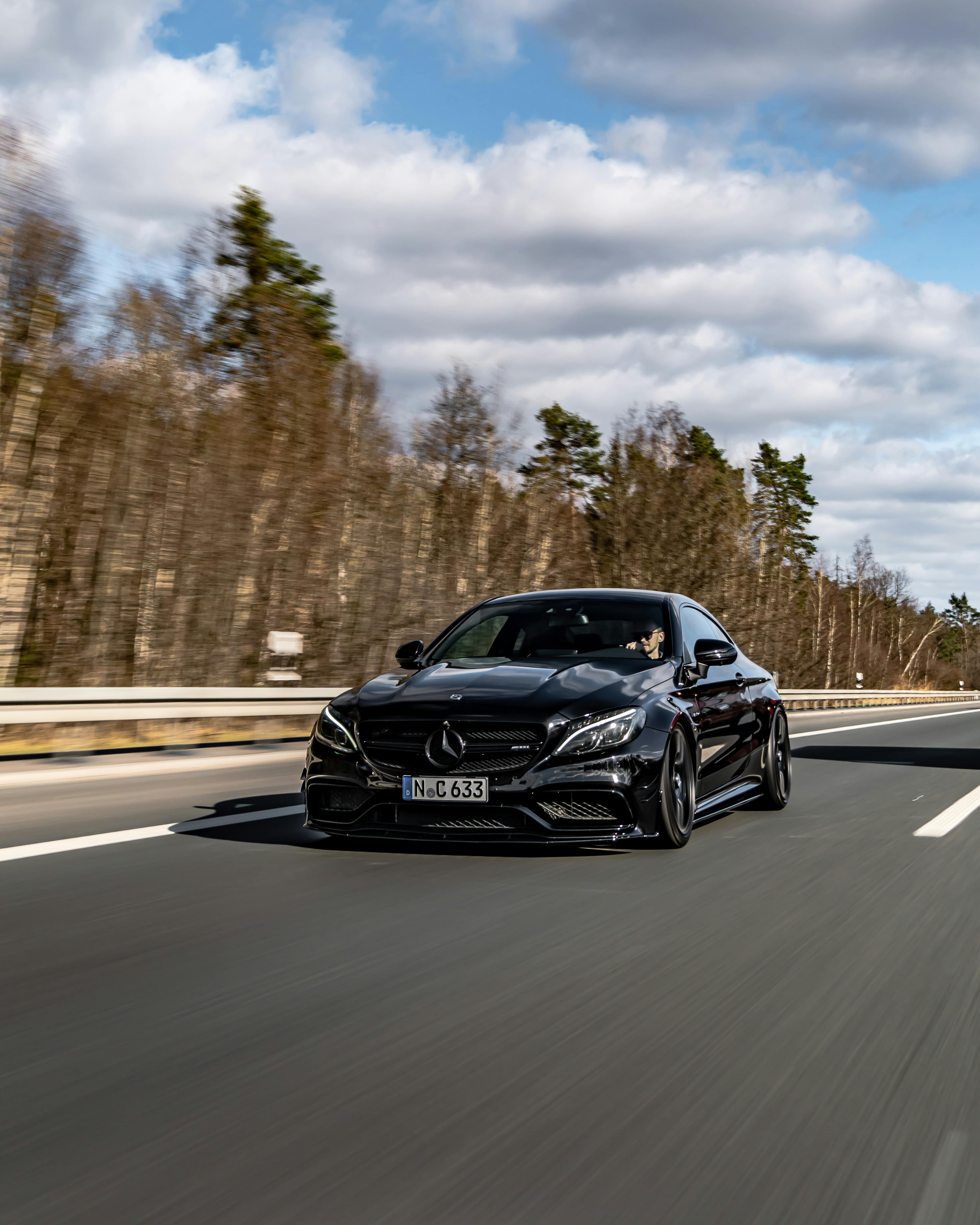 A Black Mercedes Benz C Class on a Road · Free Stock Photo