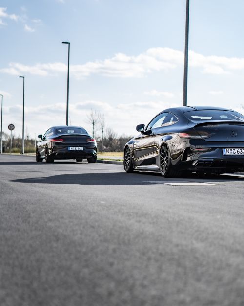 Free Two Mercedes Benz coupes parked on a sunlit road in Nürnberg, Germany. Stock Photo