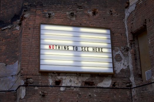 Billboard on a Brick Wall Saying Nothing to See Here 