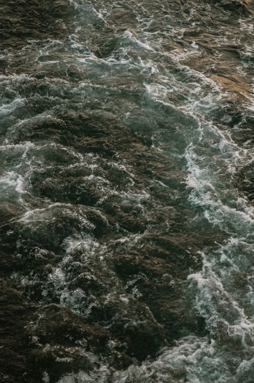 Free High angle view of swirling ocean waves showcasing dynamic natural scenery. Stock Photo