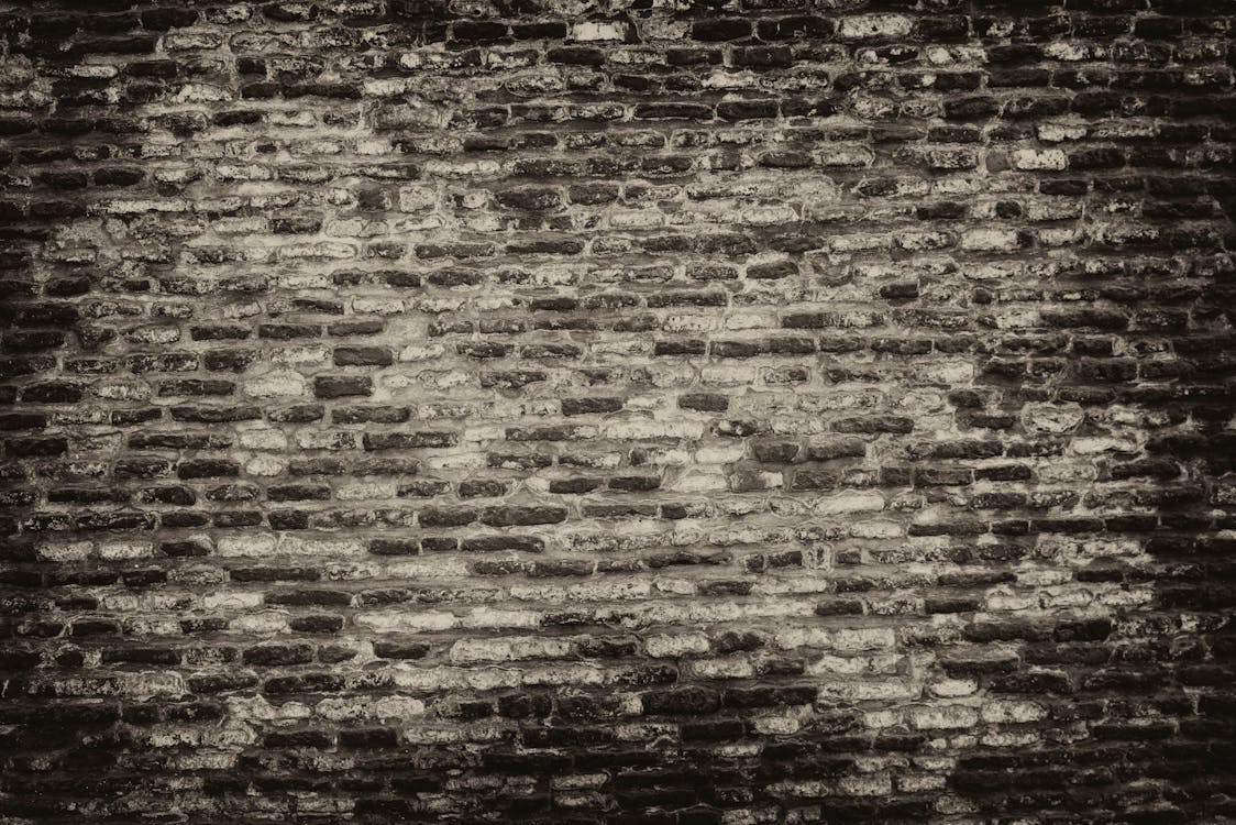 Grayscale Photo of Brickwall