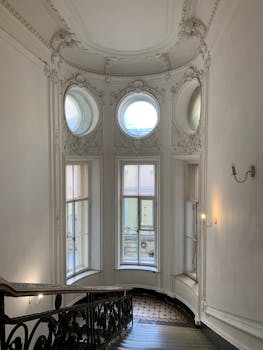 Graceful interior with ornate windows and balustrades in Sleptsov House, St Petersburg.