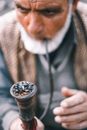 Elderly Man Smoking Using a Tobacco Pipe